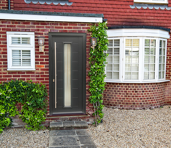 a modern front door surrounded by plants